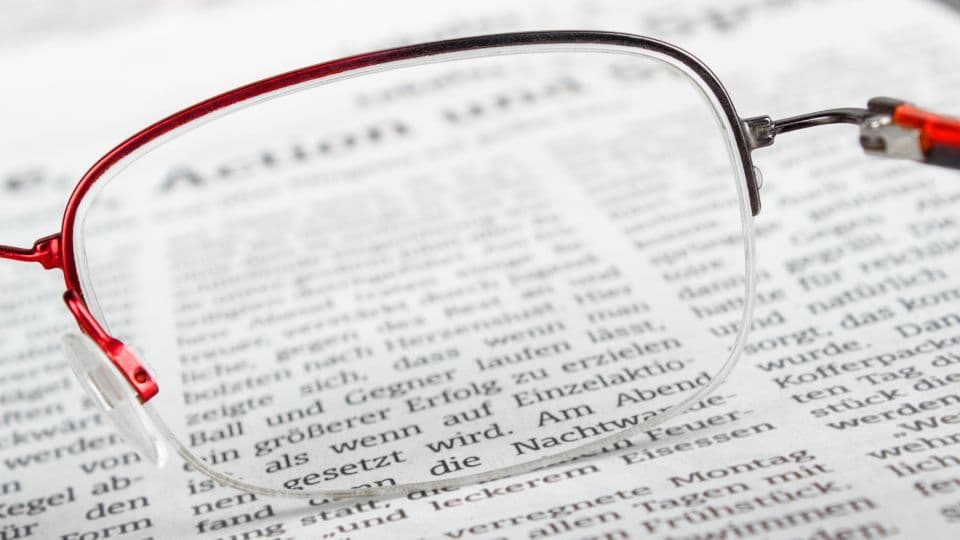 Blick durch ein Gleitsichtglas auf eine Zeitungsseite
